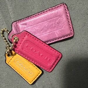 Coach Red, yellow/gold and a pink tag